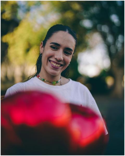 A woman smiling in a Buenos Aires park with blurre