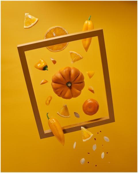A vibrant display of floating orange fruits and ve