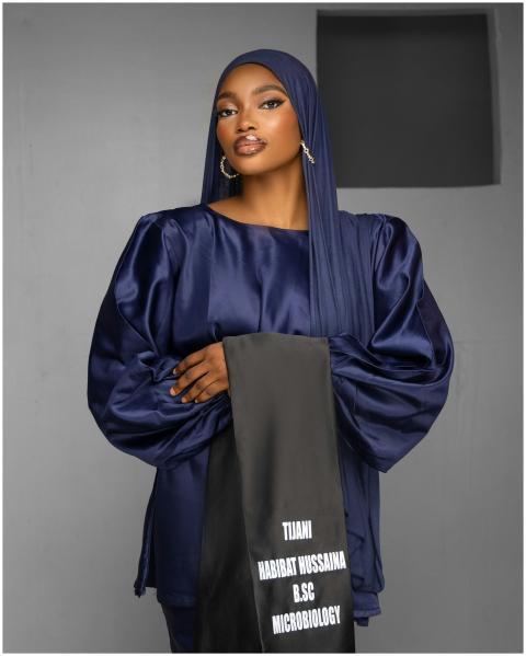 Striking portrait of a woman in navy silk attire h