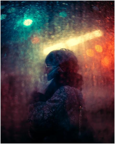 Artistic street photography of a woman talking on