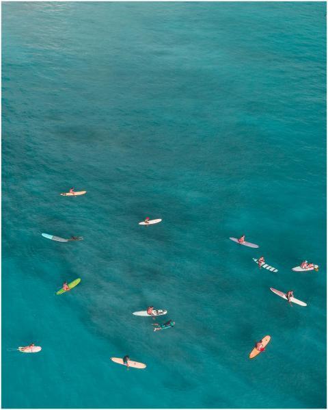 A stunning aerial photograph capturing surfers nav