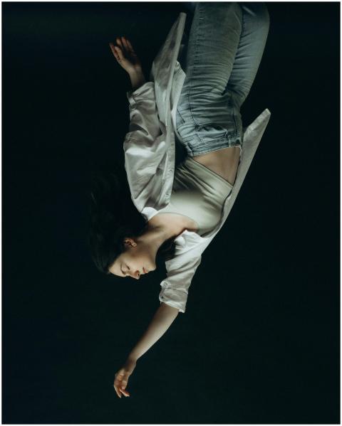 Striking upside down portrait of a woman on a dark