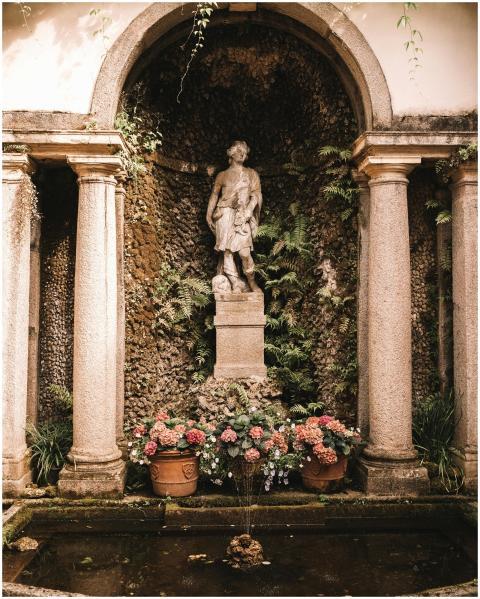 Elegant statue with a fountain surrounded by colum