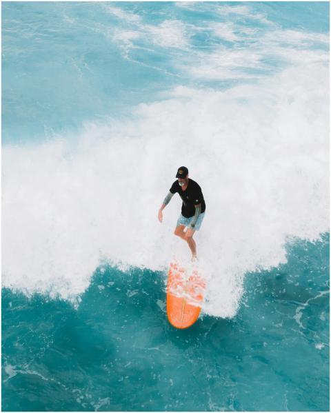 Experience the thrill of surfing on massive waves