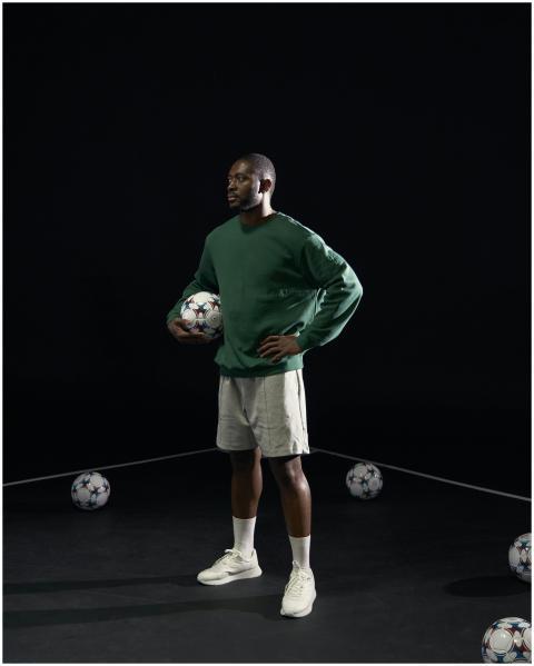Athlete standing with soccer ball, ready for train