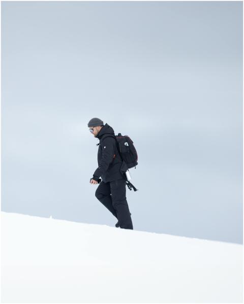 A lone explorer trekking across the snowy terrain
