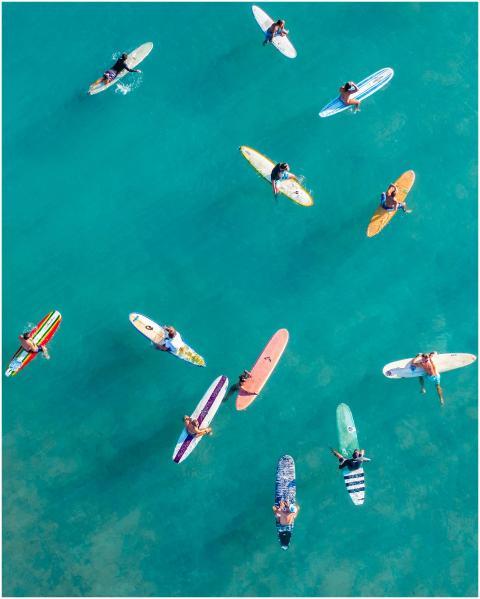 A vibrant aerial shot of surfers on colorful board