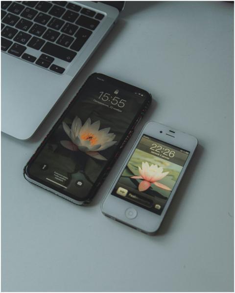 A laptop and two smartphones resting on a minimali