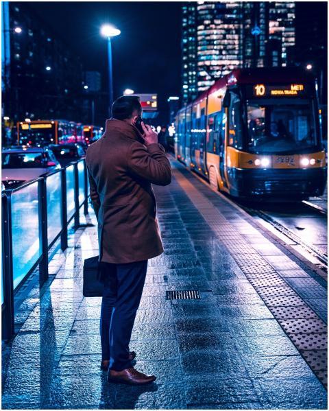 A professional man in a coat makes a phone call at