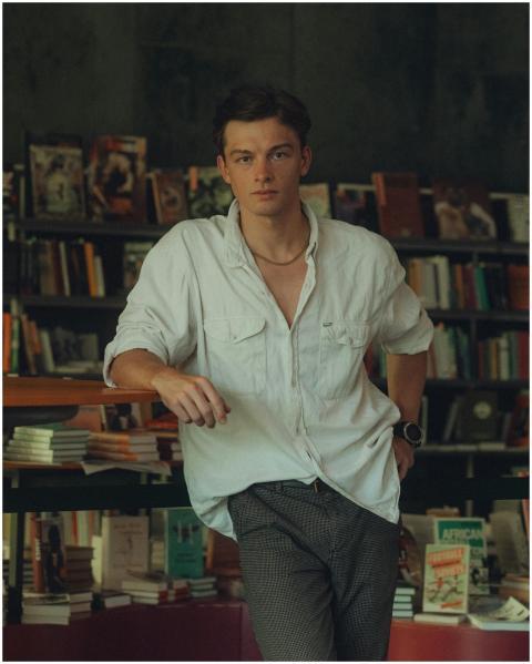 Stylish young man posing confidently in a Berlin b