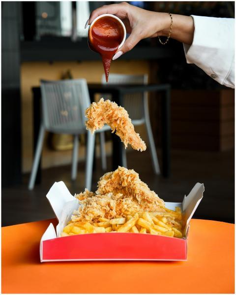 Delicious crispy fried chicken and fries with sauc
