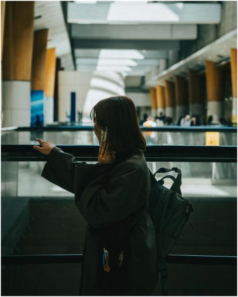 A person talking on the phone in a spacious, moder
