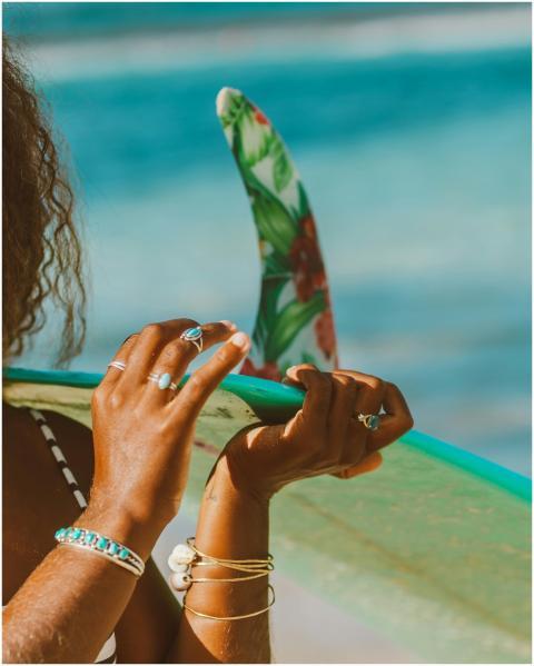 Close-up of woman's hands holding a colorful surfb