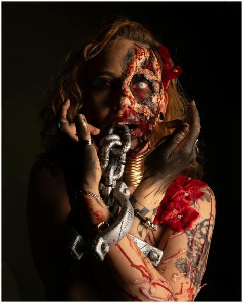 Intense portrait depicting a demon costume with ch