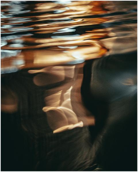Blurred abstract reflection on rippling water surf