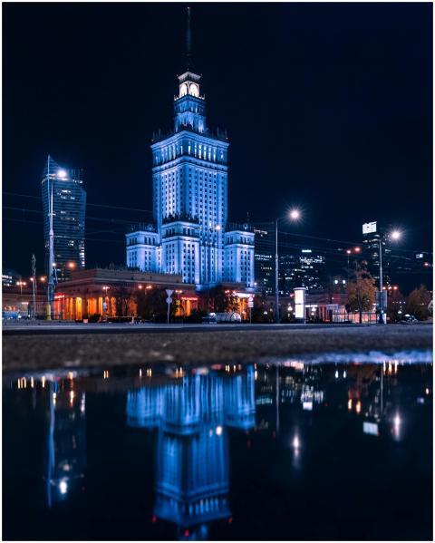 Illuminated Warsaw skyline featuring the Palace of