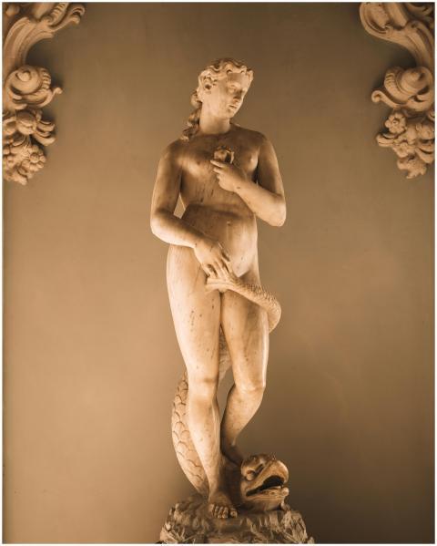Elegant marble statue of a woman with a serpent in