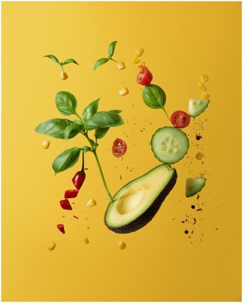 Vibrant composition of floating avocado, vegetable