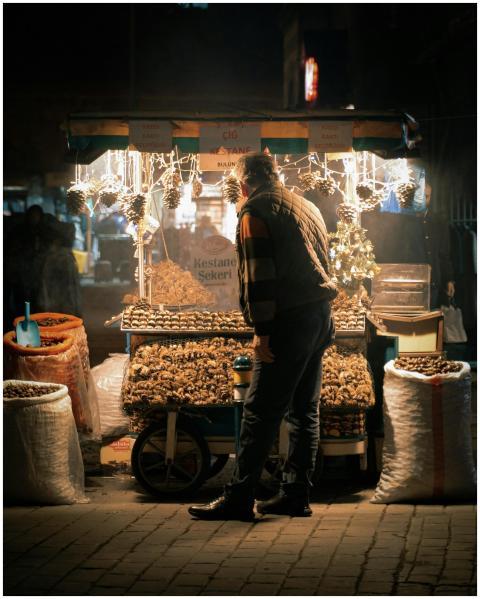 A vendor selling roasted chestnuts at a night mark