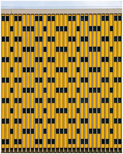 Modern geometric facade design in yellow and black