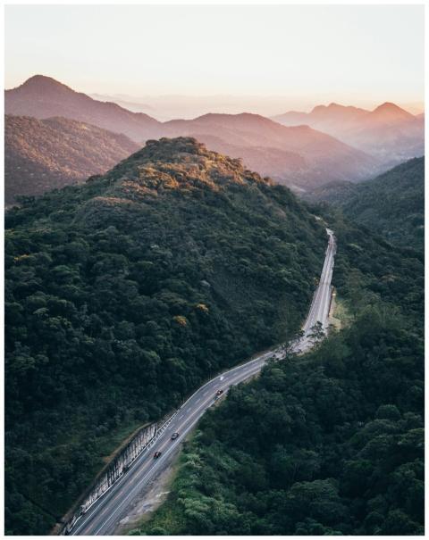 Drone captures a winding road through lush mountai
