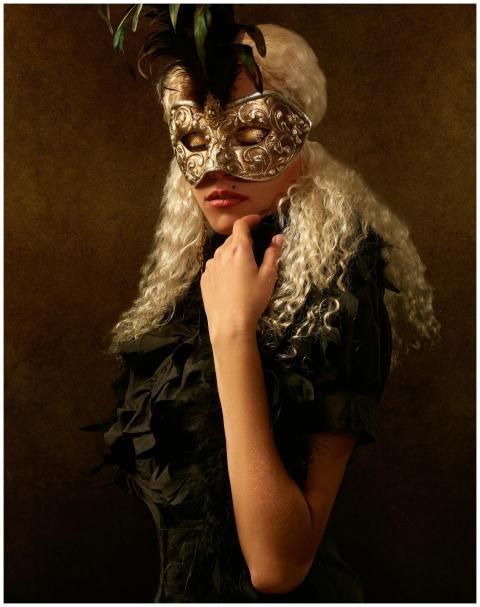 A mysterious woman in a chic masquerade costume wi