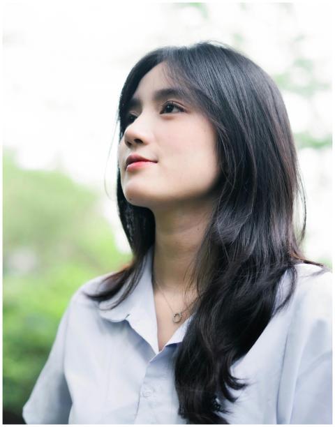 A serene portrait of a young woman with dark hair