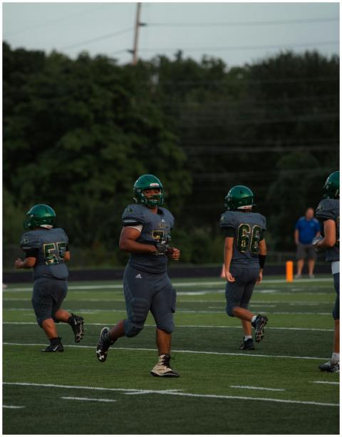 Youth football players in action on a green field,
