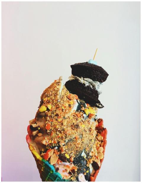 A vibrant ice cream cone stacked with colorful top