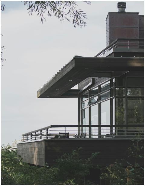 A contemporary house with glass windows and balcon