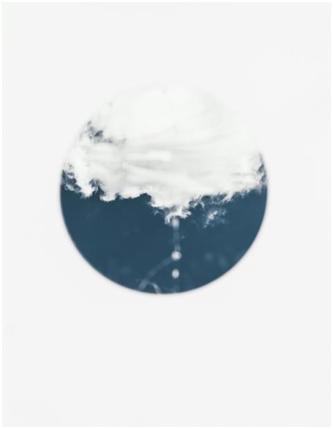 A cloud within a circular frame on a blue backgrou