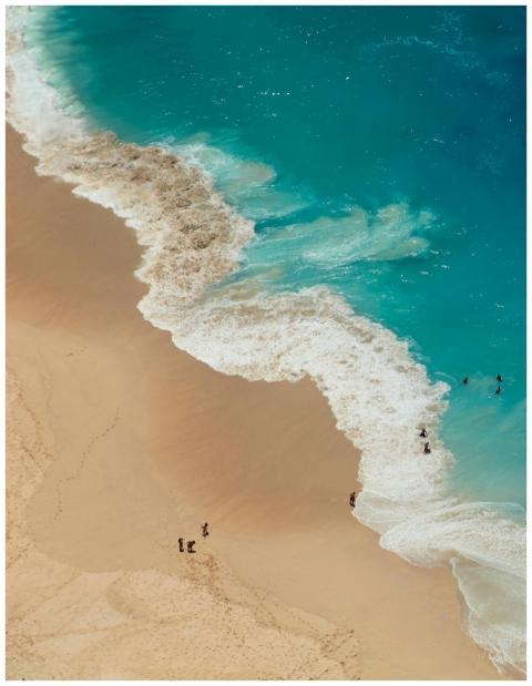 Stunning aerial shot of a beach with clear azure w