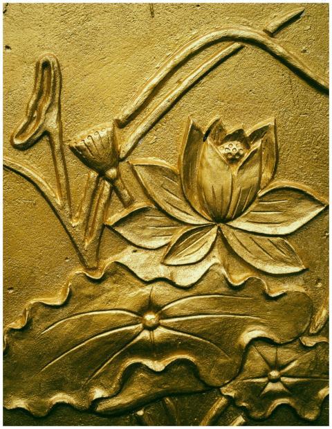 Close-up view of an intricate golden lotus flower