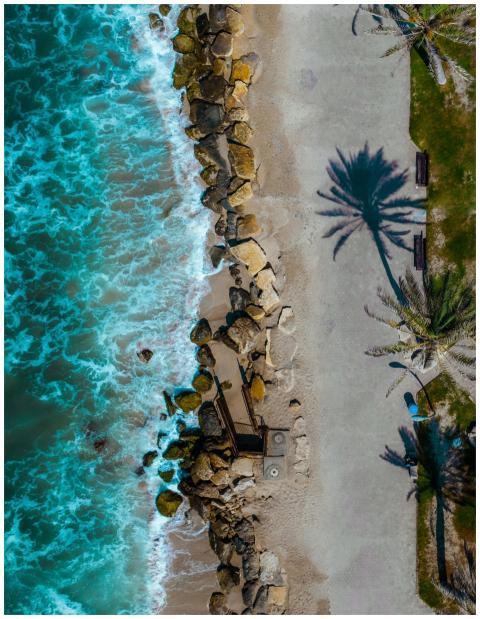 Stunning aerial shot of a tropical beach with rock