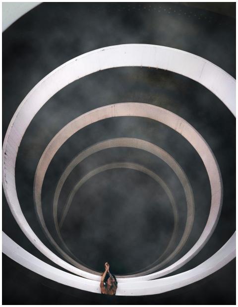 A dramatic top-down view of a spiral staircase env