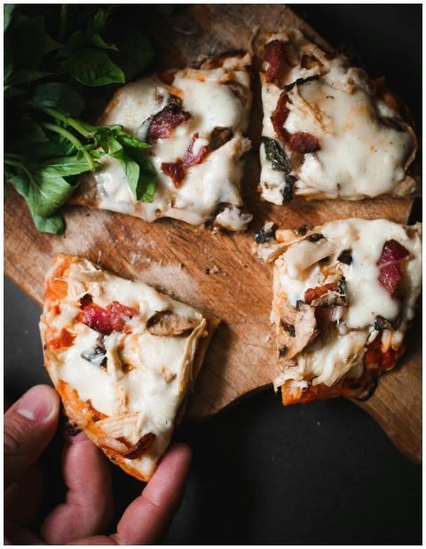 Delicious pizza slices with mozzarella, bacon, and