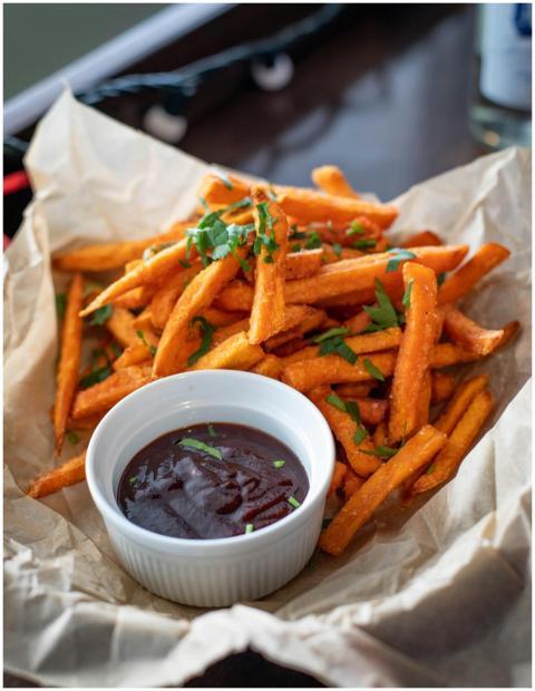 Appetizing sweet potato fries served with a rich d