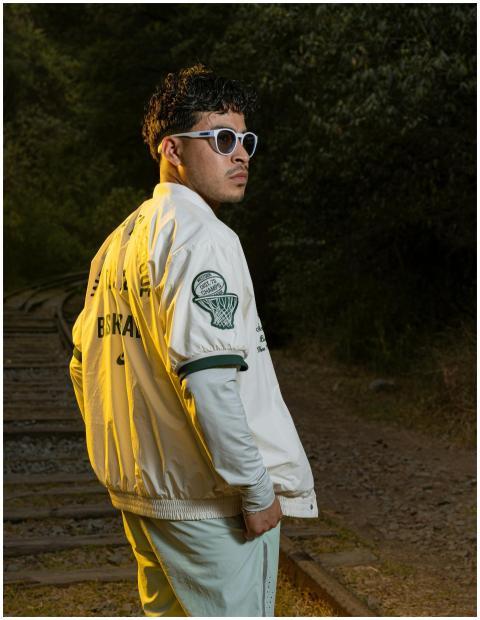 Fashionable man with sunglasses and jacket poses c