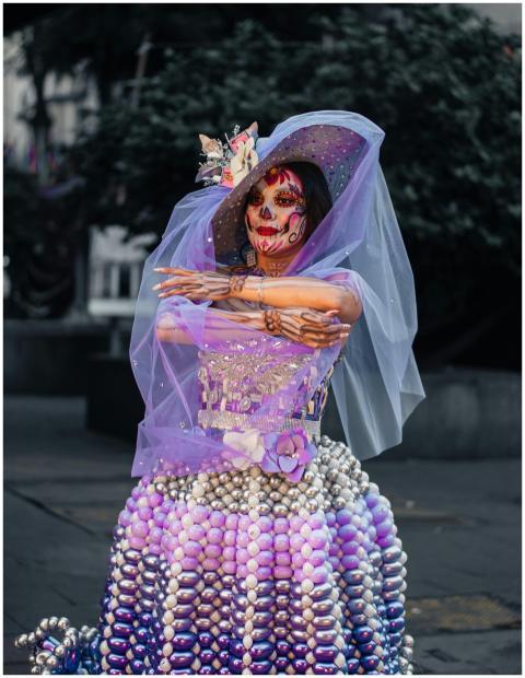 Woman in elaborate Day of the Dead costume with fa