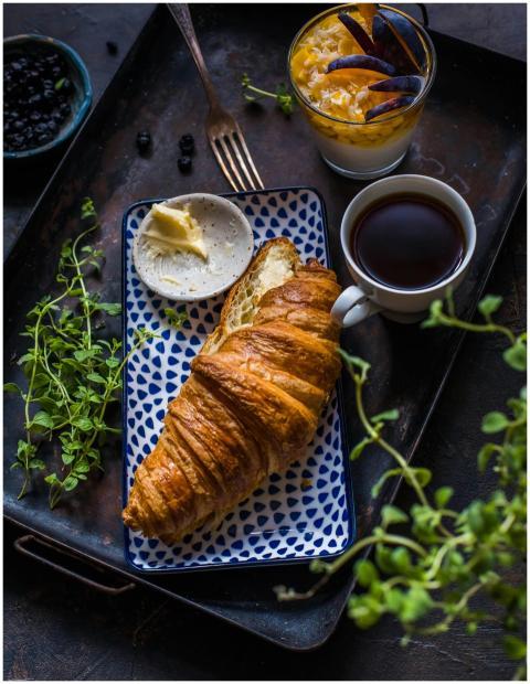 A delicious breakfast with a flaky croissant, butt