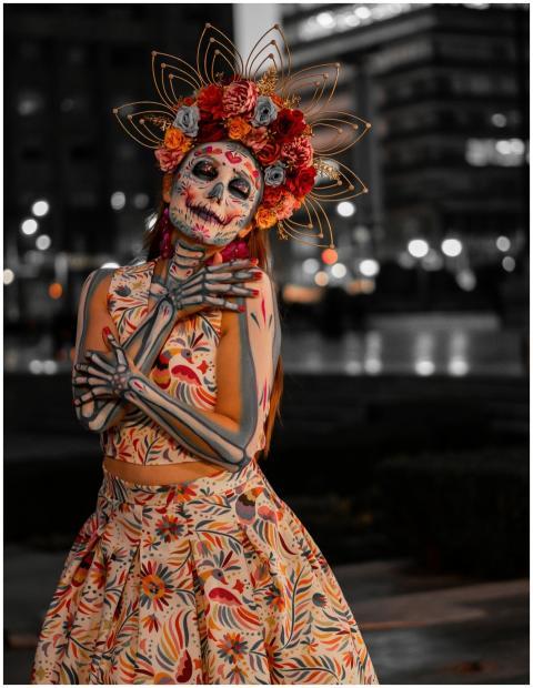 Vibrant Day of the Dead costume and makeup with fl