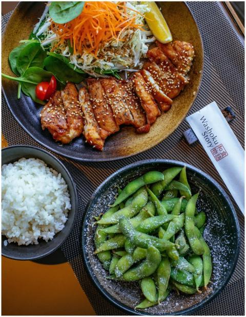 Top view of a Japanese meal featuring grilled chic