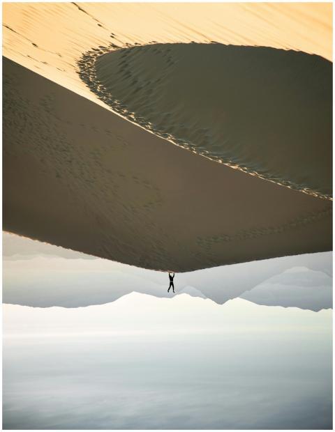A surreal desert scene featuring a lone person per