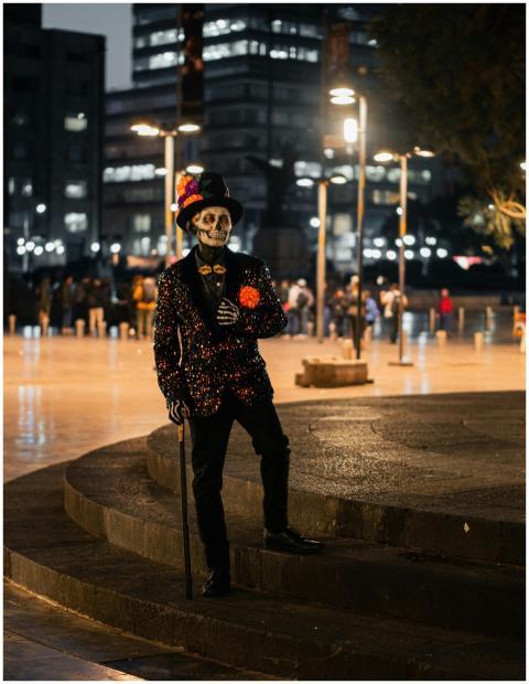 Person in skeleton costume poses in colorful outfi