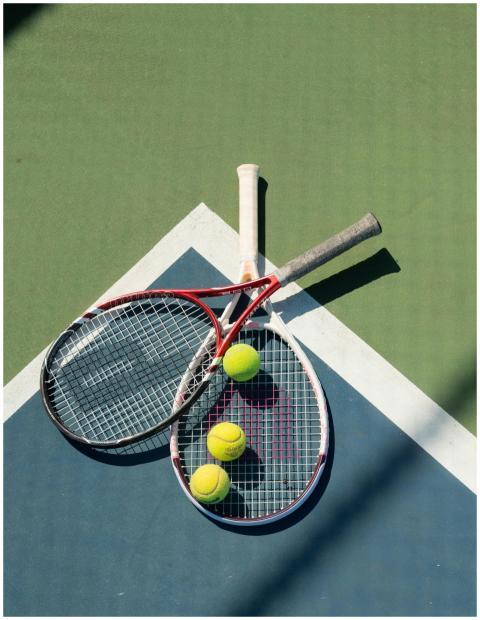 Top view of tennis rackets and balls on a colorful