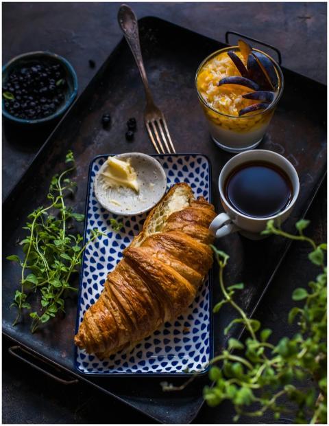 A cozy breakfast setup featuring a croissant, butt