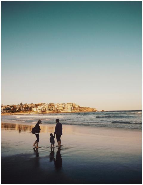 A family enjoying a peaceful walk along Bondi Beac