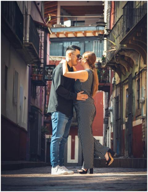 A loving couple shares a romantic embrace in a col