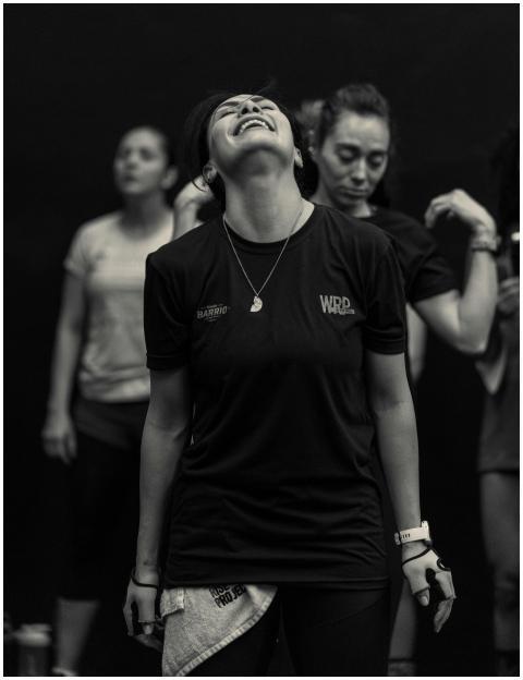 Women expressing joy and camaraderie during a grou
