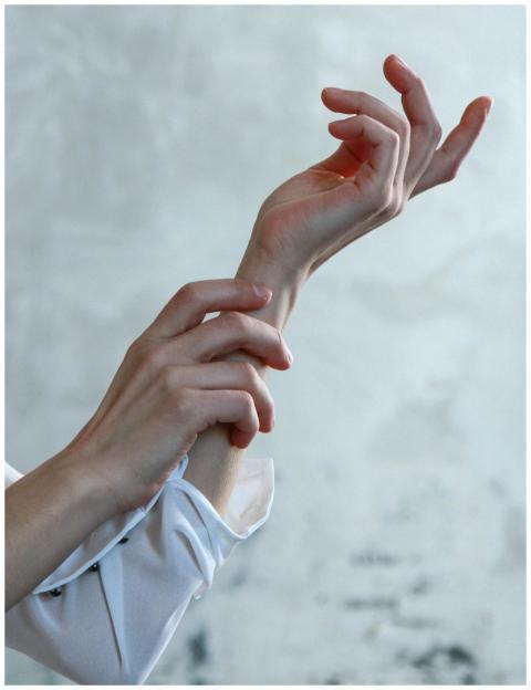 A close-up of elegant female hands in soft natural